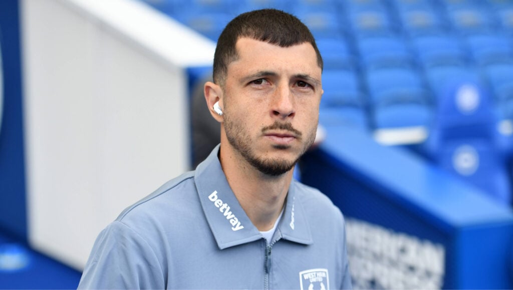 West Ham midfielder Guido Rodriguez arrives at a game with his headphones in.