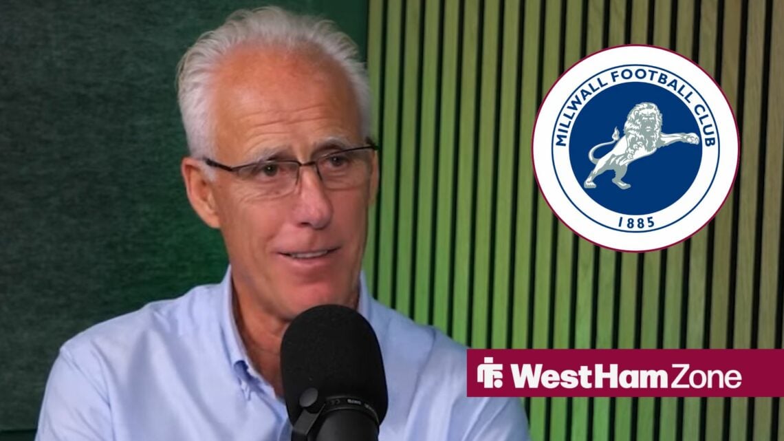 Mick McCarthy smiling looking towards a Millwall badge in a circle inset