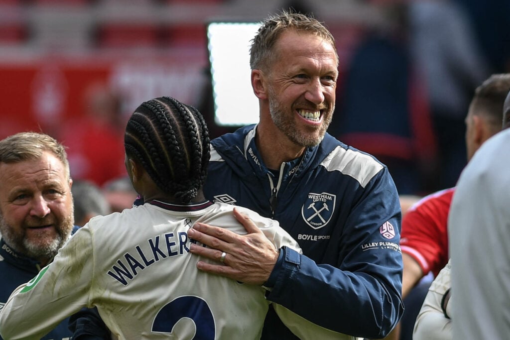 Graham Potter smiling and hugging Kyle Walker-Peters