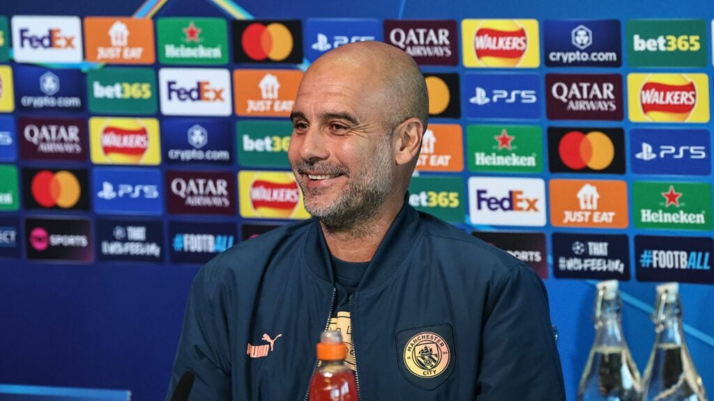 Manchester City boss Pep Guardiola smiling.